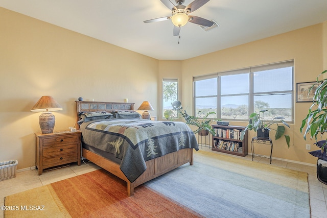 bedroom with ceiling fan and light tile patterned flooring