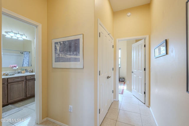 hall featuring light tile patterned flooring