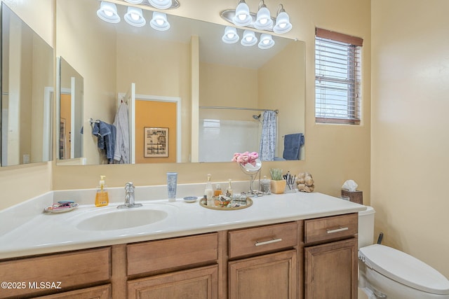 bathroom with vanity, toilet, and a shower with shower curtain