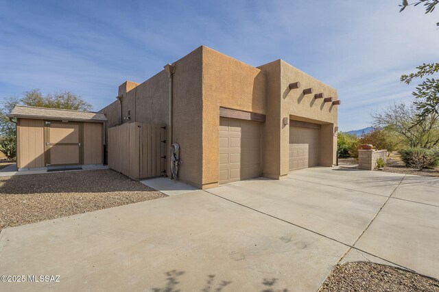 view of front of house with a garage and a shed