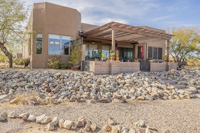 back of house featuring a pergola