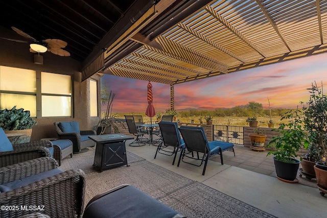 patio terrace at dusk featuring an outdoor hangout area and a pergola