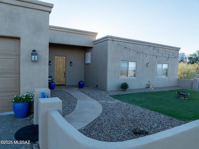 doorway to property featuring a lawn