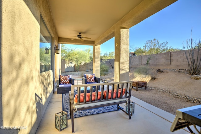 view of patio / terrace with ceiling fan and an outdoor fire pit