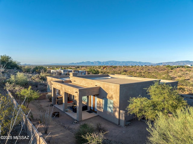 exterior space featuring a mountain view and a patio area