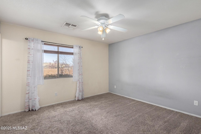 carpeted spare room featuring ceiling fan