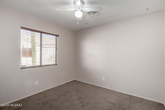 carpeted empty room featuring ceiling fan