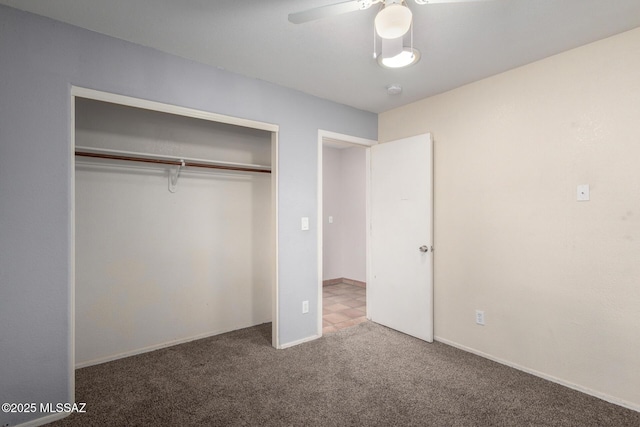 unfurnished bedroom featuring ceiling fan, a closet, and carpet