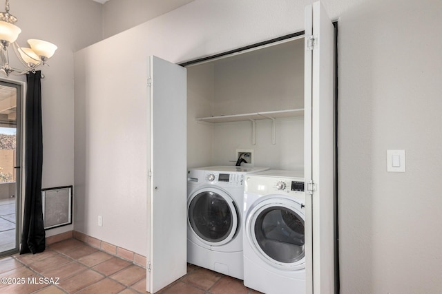 washroom with tile patterned flooring, a notable chandelier, and washer and clothes dryer