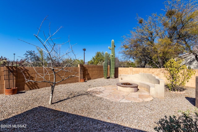 view of yard featuring a patio area and a fire pit