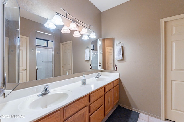 bathroom featuring vanity, tile patterned flooring, and a shower with door