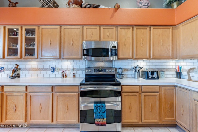 kitchen featuring backsplash, appliances with stainless steel finishes, and light brown cabinets