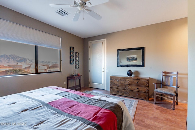 bedroom with hardwood / wood-style flooring and ceiling fan