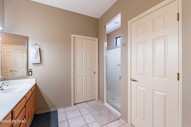 bathroom with vanity, a shower with shower door, and tile patterned flooring