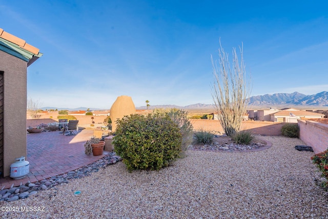 view of yard with a mountain view and a patio area