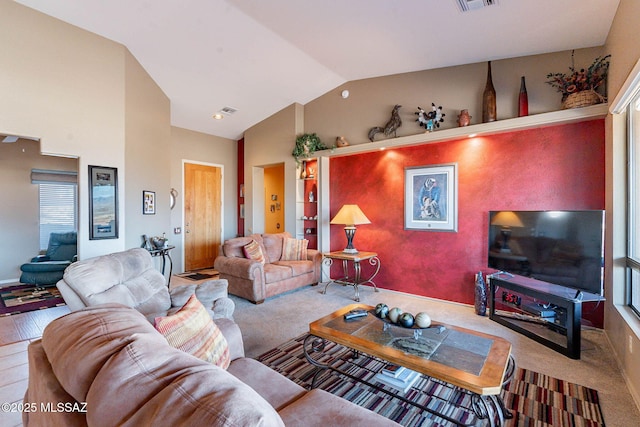 living room featuring lofted ceiling and carpet