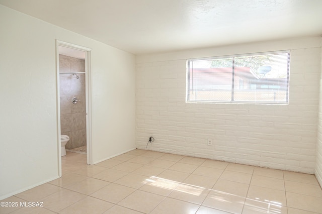 unfurnished room with light tile patterned flooring