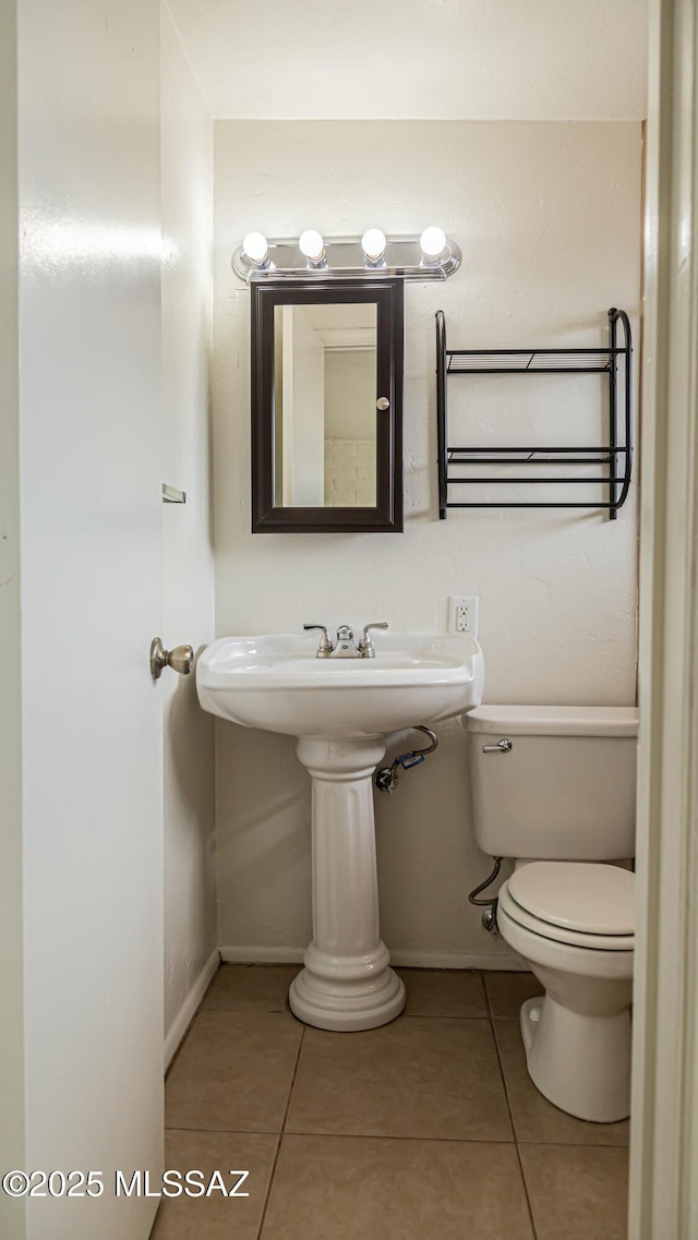 bathroom featuring radiator, tile patterned floors, and toilet