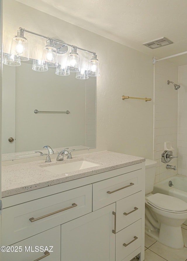 full bathroom with tiled shower / bath, vanity, toilet, and tile patterned floors