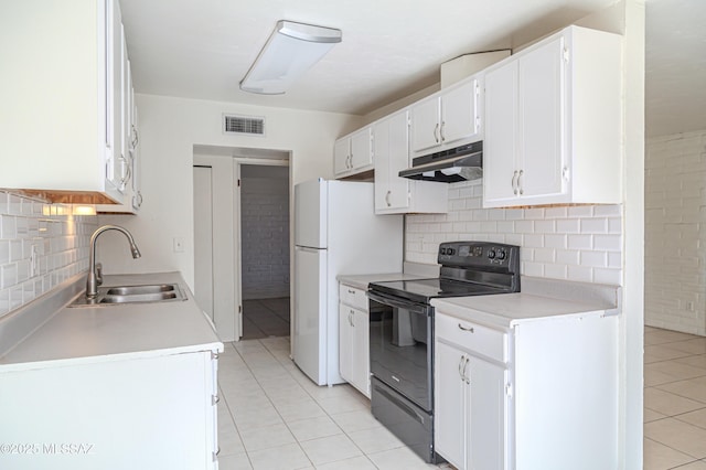 kitchen with black electric range oven, light tile patterned floors, sink, white cabinetry, and tasteful backsplash