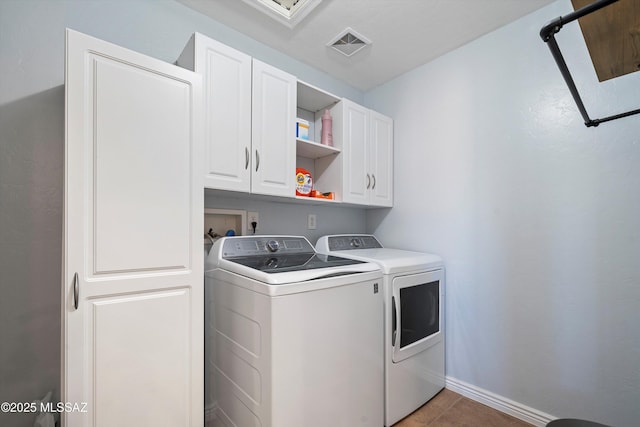 laundry room with cabinets, separate washer and dryer, and light tile patterned floors