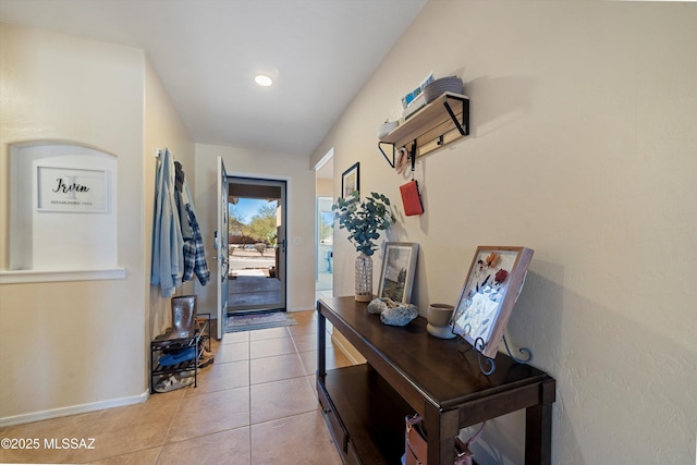 doorway to outside with light tile patterned floors