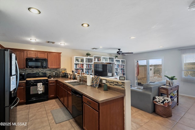 kitchen featuring light tile patterned flooring, sink, black appliances, kitchen peninsula, and backsplash