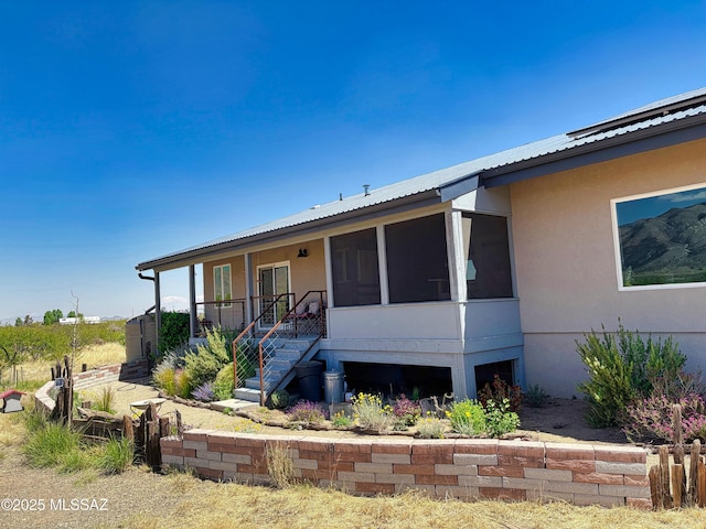 1155 N Dakotas Trl, Cochise, AZ 85606 - view of front facade featuring stucco siding, metal roof, and a sunroom