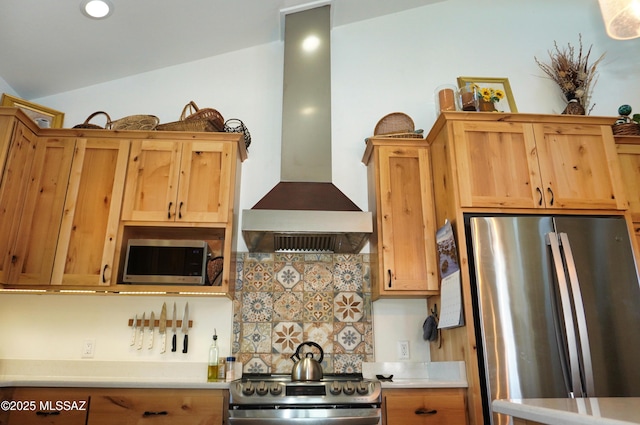 kitchen with backsplash, vaulted ceiling, wall chimney exhaust hood, and appliances with stainless steel finishes