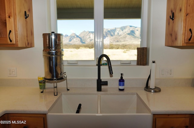 kitchen featuring a mountain view and sink