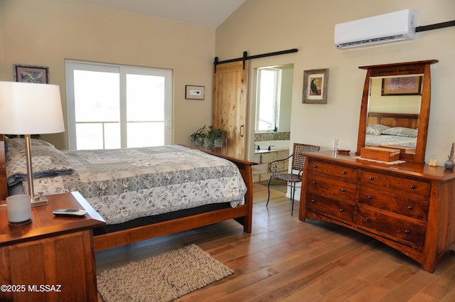 bedroom with wood-type flooring, vaulted ceiling, multiple windows, and an AC wall unit