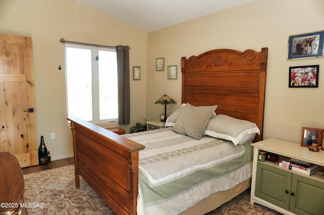 bedroom featuring lofted ceiling and hardwood / wood-style floors