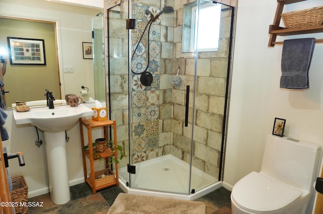 bathroom with toilet and a shower with shower door