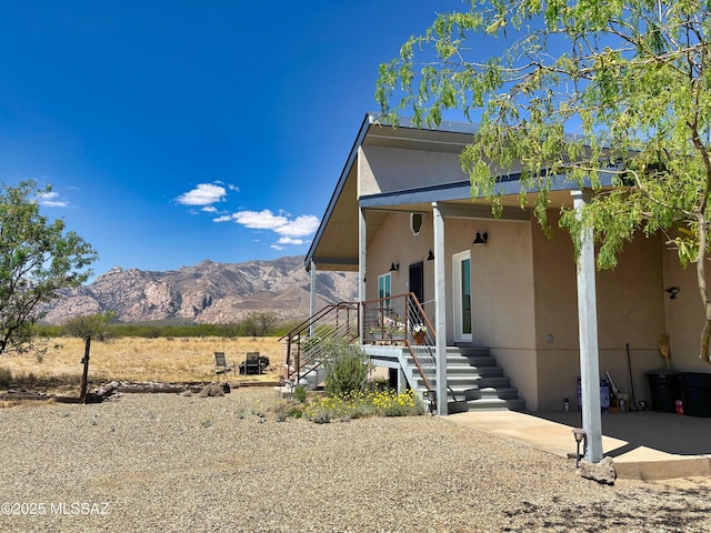 1155 N Dakotas Trl, Cochise, AZ 85606 - view of home's exterior featuring a mountain view, stucco siding, stairway, and a patio area