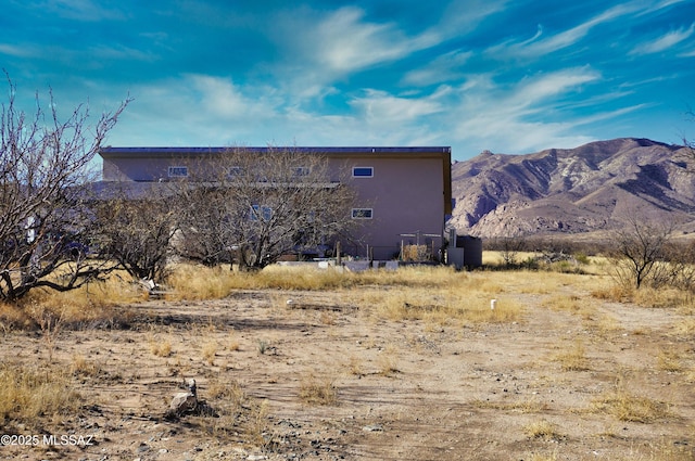 rear view of property featuring a mountain view