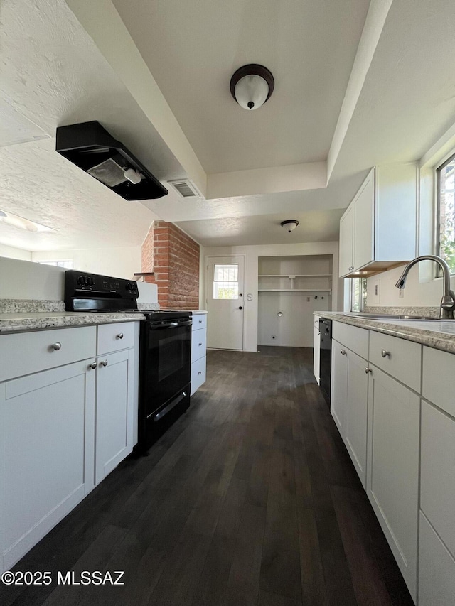 kitchen featuring sink, white cabinets, black appliances, a raised ceiling, and dark wood-type flooring