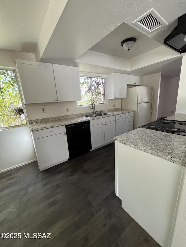 kitchen with dishwasher, white cabinets, white fridge, a raised ceiling, and dark wood-type flooring