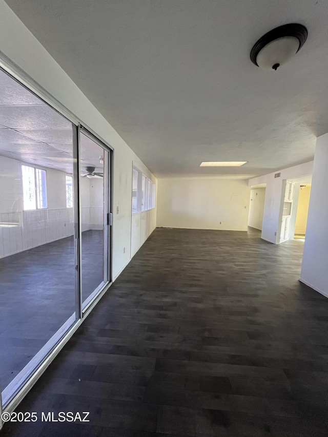 hallway with dark hardwood / wood-style flooring