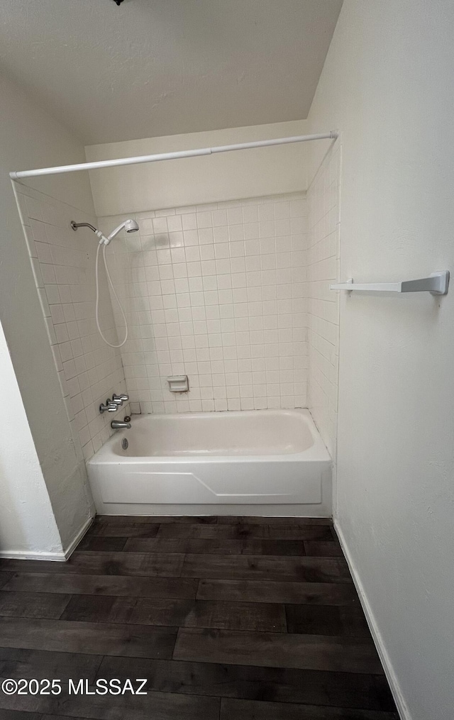 bathroom featuring hardwood / wood-style flooring and tiled shower / bath