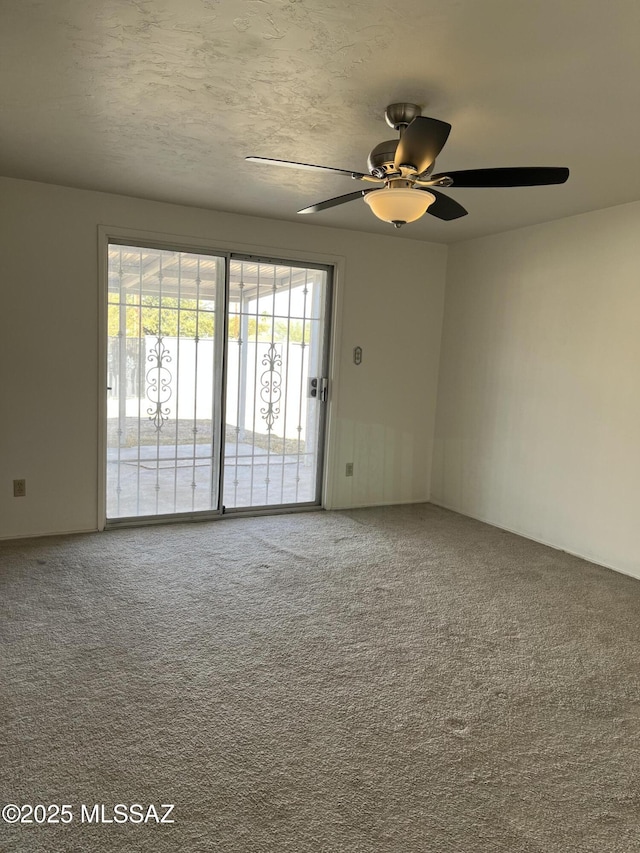 carpeted empty room featuring a water view and ceiling fan