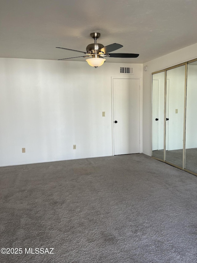 unfurnished bedroom with ceiling fan and carpet