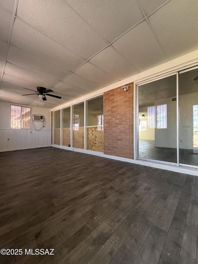 interior space featuring ceiling fan and a paneled ceiling