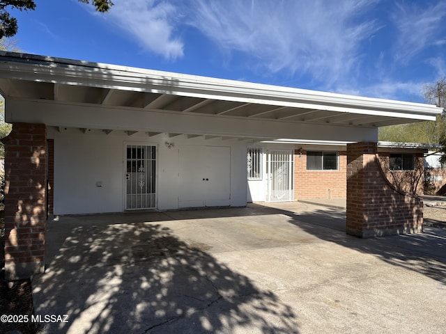 rear view of property featuring a carport