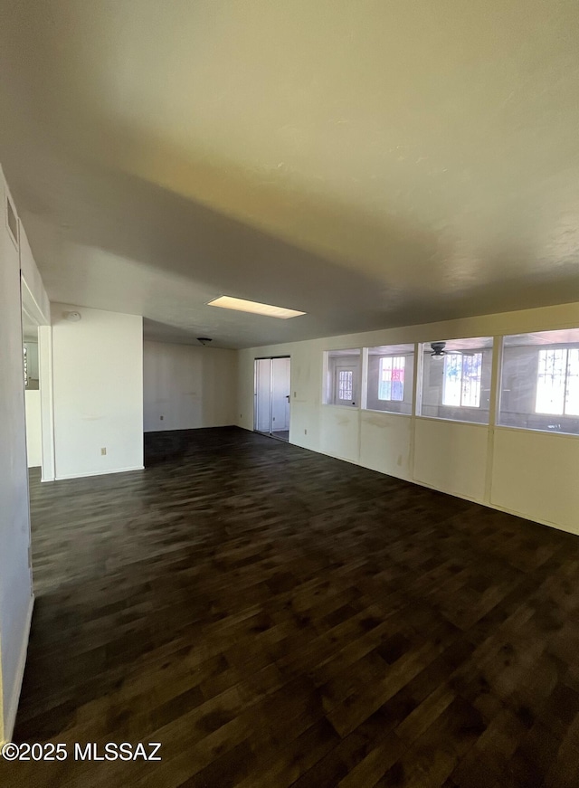 unfurnished room with dark hardwood / wood-style flooring