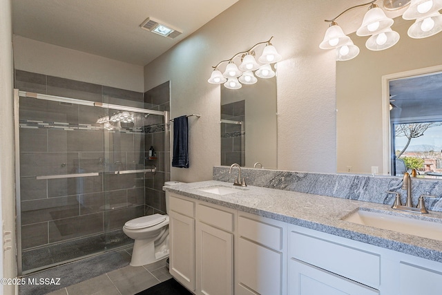 bathroom with vanity, toilet, an enclosed shower, and tile patterned flooring