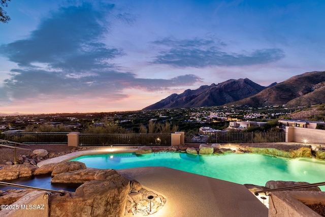 pool at dusk with a mountain view