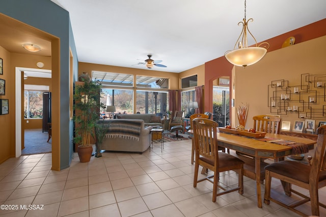 dining area with light tile patterned floors and ceiling fan