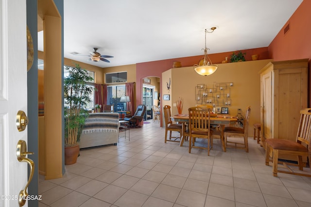 tiled dining space featuring ceiling fan