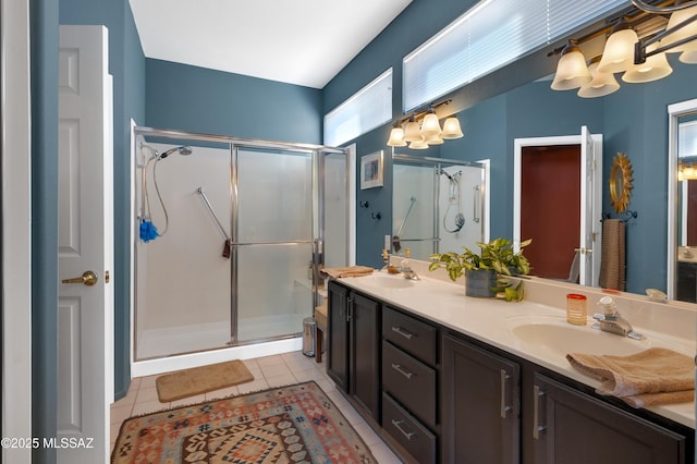 bathroom featuring tile patterned floors, an enclosed shower, and vanity