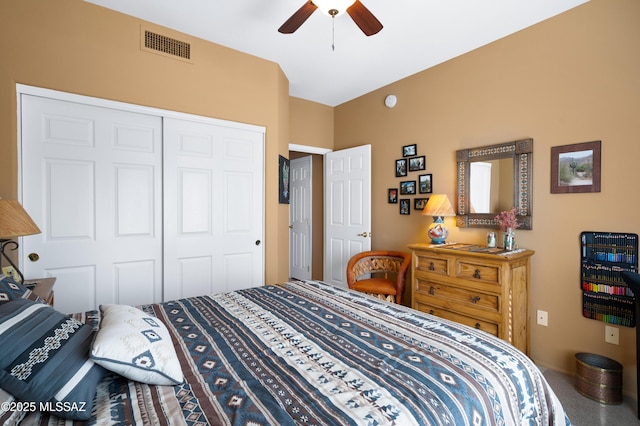 carpeted bedroom featuring ceiling fan and a closet